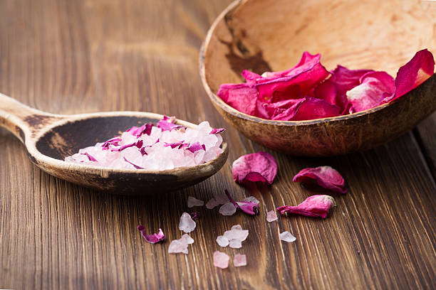 Homeopathic medicine, rose dry flowers and wooden surface.