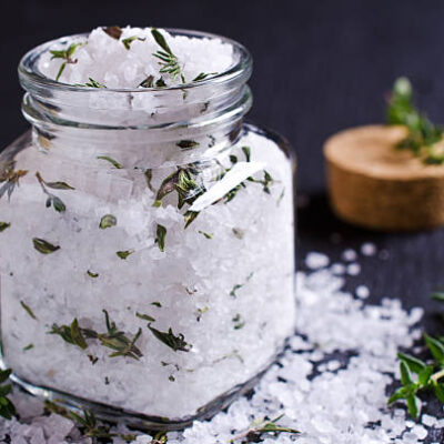 Salt and thyme in a glass on a dark background. selective focus.