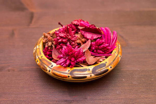 Bowl with pot pourri on a wooden table